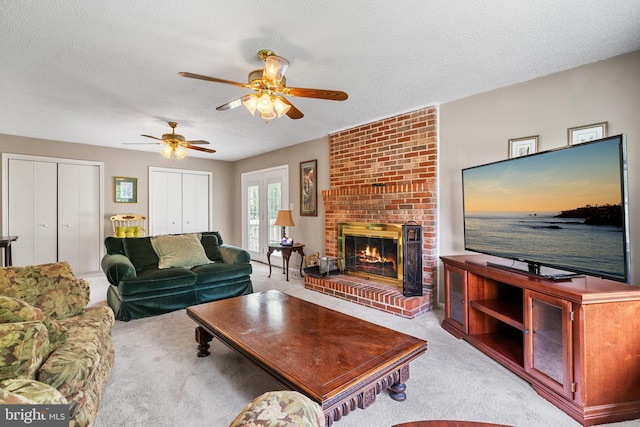 23359 Patuxent View Rd, Lexington Park, MD 20653 - living room featuring light carpet, ceiling fan, a fireplace, and a textured ceiling
