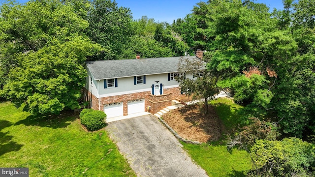 23359 Patuxent View Rd, Lexington Park, MD 20653 - raised ranch with asphalt driveway, a chimney, a garage, brick siding, and a front lawn