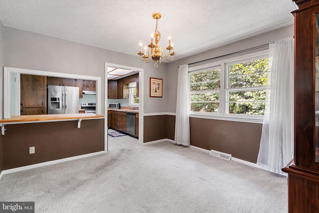 23359 Patuxent View Rd, Lexington Park, MD 20653 - unfurnished dining area with a chandelier, light carpet, a textured ceiling, and baseboards