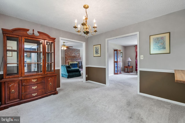 23359 Patuxent View Rd, Lexington Park, MD 20653 - dining area featuring carpet, a chandelier, a textured ceiling, a fireplace, and a ceiling fan