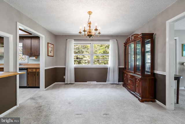 23359 Patuxent View Rd, Lexington Park, MD 20653 - unfurnished dining area featuring light colored carpet, a chandelier, a textured ceiling, and baseboards