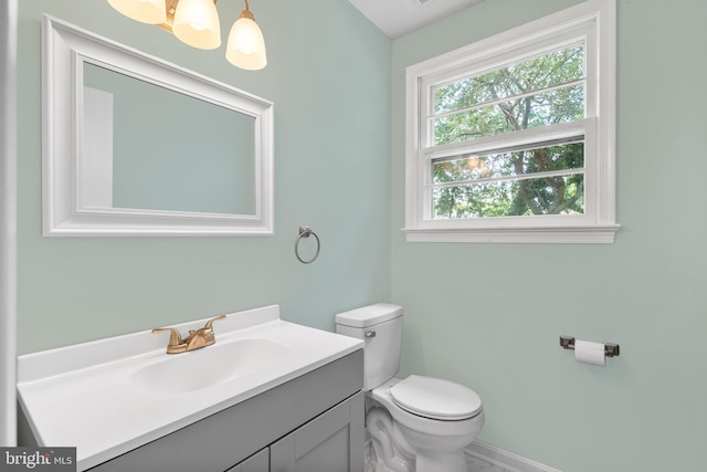 23359 Patuxent View Rd, Lexington Park, MD 20653 - bathroom with vanity, toilet, baseboards, and a chandelier