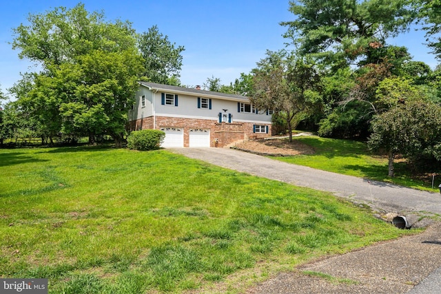 23359 Patuxent View Rd, Lexington Park, MD 20653 - bi-level home with driveway, an attached garage, a front yard, a chimney, and brick siding