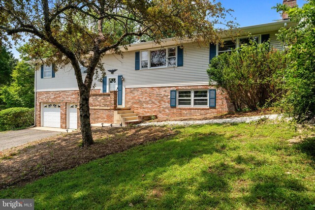 23359 Patuxent View Rd, Lexington Park, MD 20653 - split foyer home with brick siding, an attached garage, driveway, and a front yard