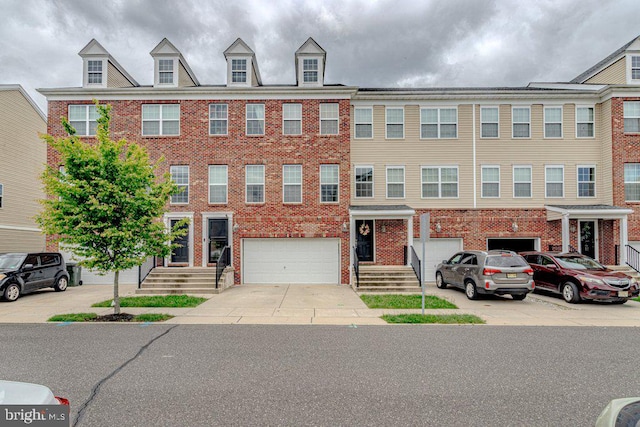 109 Riverwalk Blvd, Burlington, NJ 08016 - view of property featuring an attached garage, brick siding, and concrete driveway
