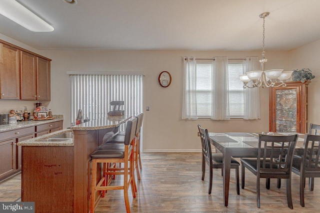 109 Riverwalk Blvd, Burlington, NJ 08016 - dining room with light wood-style floors, a chandelier, and baseboards