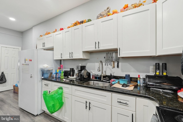 3125 N 7th St, Philadelphia, PA 19133 - kitchen with freestanding refrigerator, a sink, light wood finished floors, white cabinetry, and range with electric stovetop