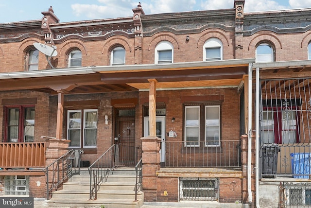 3125 N 7th St, Philadelphia, PA 19133 - townhome / multi-family property featuring brick siding and a porch