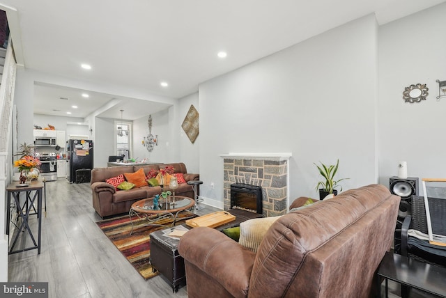 3125 N 7th St, Philadelphia, PA 19133 - living room with light wood-style floors, a stone fireplace, and recessed lighting