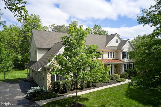 529 Sugartown Rd, Berwyn, PA 19312 - view of front facade with stone siding, a front yard, board and batten siding, and a standing seam roof