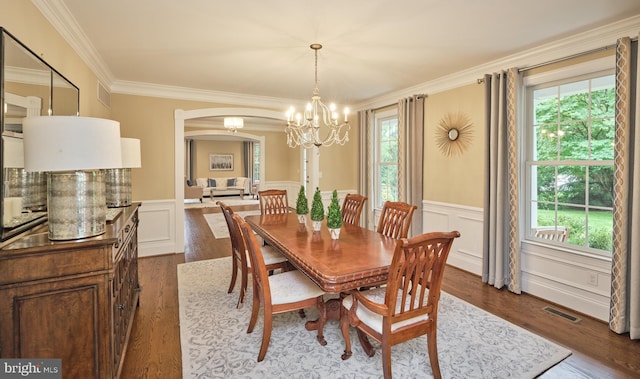 529 Sugartown Rd, Berwyn, PA 19312 - dining space with a chandelier, arched walkways, healthy amount of natural light, crown molding, and dark wood finished floors