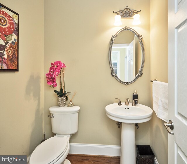 529 Sugartown Rd, Berwyn, PA 19312 - half bath with toilet, wood finished floors, and baseboards