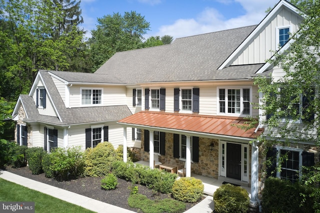 529 Sugartown Rd, Berwyn, PA 19312 - view of front of house featuring covered porch, board and batten siding, a shingled roof, and stone siding