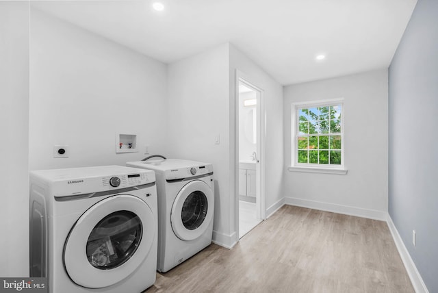 10 W Pomona St, Philadelphia, PA 19144 - washroom featuring light wood-type flooring, separate washer and dryer, baseboards, recessed lighting, and a sink