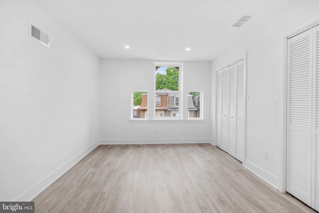 10 W Pomona St, Philadelphia, PA 19144 - unfurnished bedroom with wood finished floors, baseboards, recessed lighting, and multiple closets