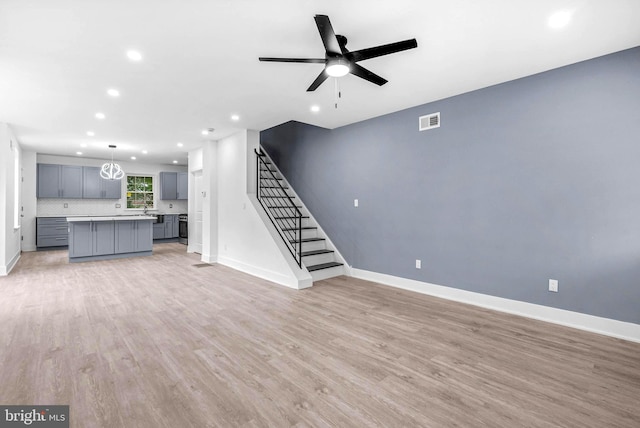 10 W Pomona St, Philadelphia, PA 19144 - unfurnished living room featuring recessed lighting, baseboards, light wood-type flooring, ceiling fan, and stairway
