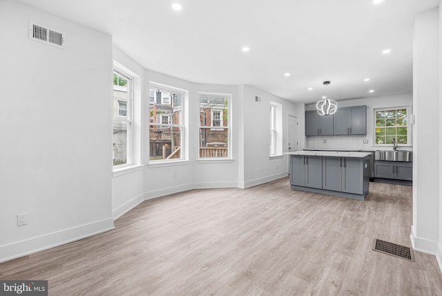 10 W Pomona St, Philadelphia, PA 19144 - kitchen featuring gray cabinetry, a sink, a center island, recessed lighting, and light wood-style flooring