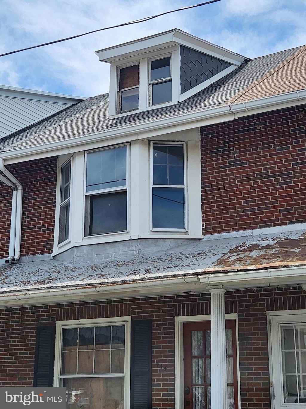 444 Moss St, Reading, PA 19604 - exterior view of brick siding, a shingled roof, and gutters