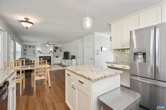 1902 English Oaks Cir N, Charlottesville, VA 22911 - kitchen with appliances with stainless steel finishes, a ceiling fan, wood finished floors, a fireplace, and tasteful backsplash