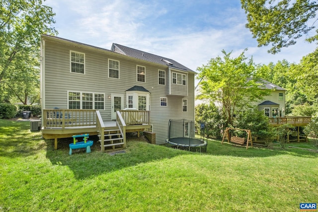 1902 English Oaks Cir N, Charlottesville, VA 22911 - rear view of house featuring a trampoline, a wooden deck, central AC unit, and a yard