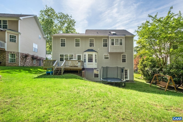 1902 English Oaks Cir N, Charlottesville, VA 22911 - back of property featuring a trampoline, a yard, a deck, and a playground
