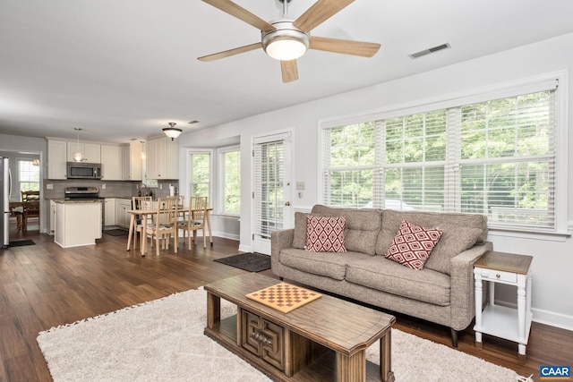 1902 English Oaks Cir N, Charlottesville, VA 22911 - living area featuring plenty of natural light, baseboards, dark wood-style flooring, and ceiling fan