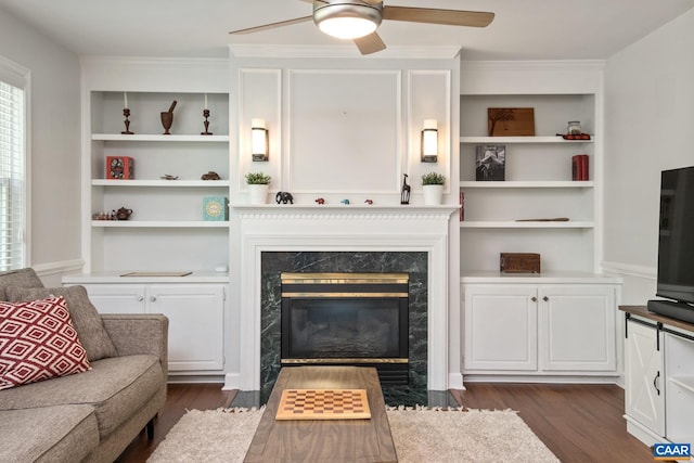 1902 English Oaks Cir N, Charlottesville, VA 22911 - living room featuring a high end fireplace, a ceiling fan, dark wood-style floors, built in features, and crown molding