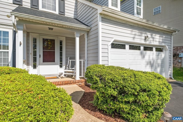 1902 English Oaks Cir N, Charlottesville, VA 22911 - view of exterior entry featuring a garage, a shingled roof, asphalt driveway, and a porch