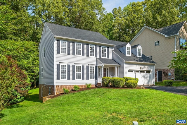 1902 English Oaks Cir N, Charlottesville, VA 22911 - colonial-style house featuring driveway, an attached garage, a front lawn, a shingled roof, and view of scattered trees