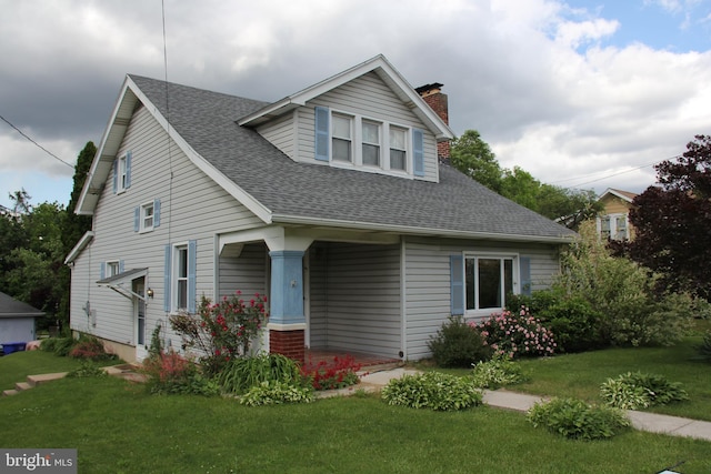 5077 Lincoln Hwy W, Thomasville, PA 17364 - view of front of property with a chimney, a front lawn, a shingled roof, and a porch