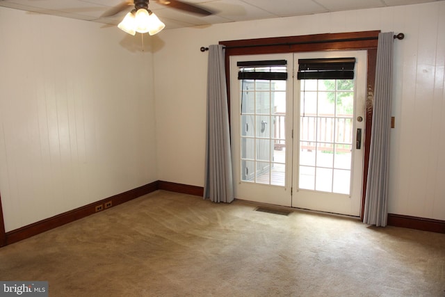 5077 Lincoln Hwy W, Thomasville, PA 17364 - unfurnished room with light carpet, ceiling fan, baseboards, and wood walls