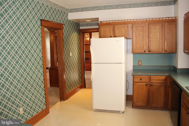 5077 Lincoln Hwy W, Thomasville, PA 17364 - kitchen with freestanding refrigerator, wallpapered walls, dishwasher, and brown cabinetry