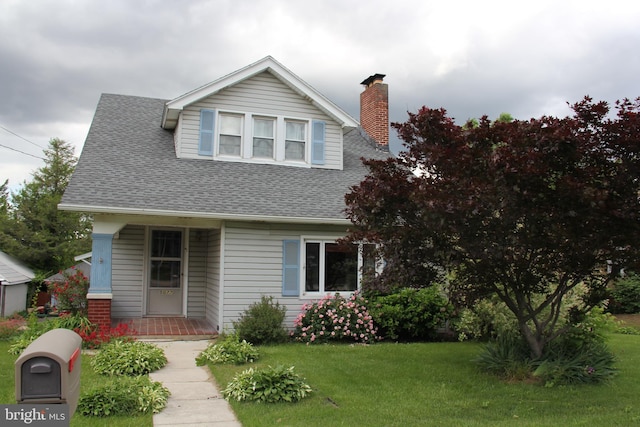 5077 Lincoln Hwy W, Thomasville, PA 17364 - bungalow-style home featuring a front yard, roof with shingles, a chimney, and covered porch