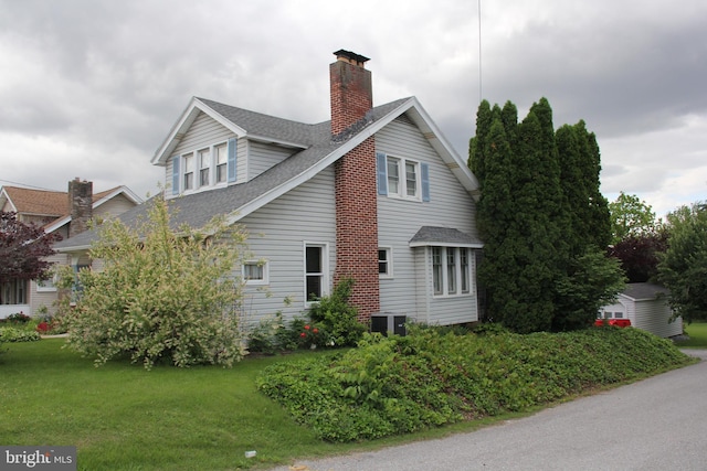 5077 Lincoln Hwy W, Thomasville, PA 17364 - view of side of home featuring a chimney, roof with shingles, and a yard