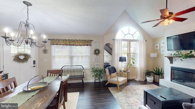 240 Dogwood Dr, Romney, WV 26757 - dining space with a chandelier, dark wood-style flooring, vaulted ceiling, a fireplace, and a ceiling fan
