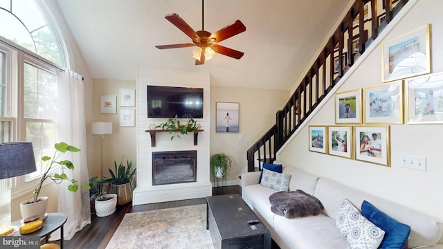 240 Dogwood Dr, Romney, WV 26757 - living area featuring vaulted ceiling, stairs, dark wood-style floors, a ceiling fan, and a large fireplace