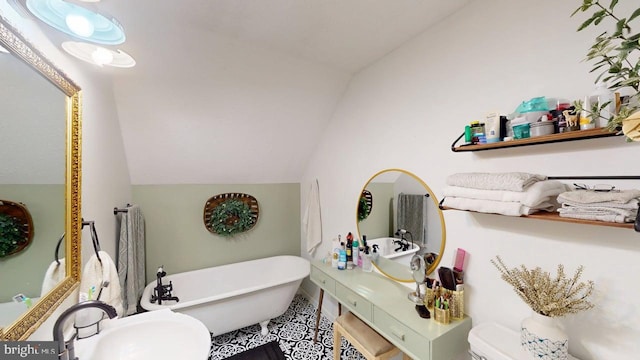 240 Dogwood Dr, Romney, WV 26757 - bathroom with vaulted ceiling, a freestanding bath, a sink, and toilet