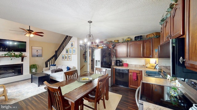 240 Dogwood Dr, Romney, WV 26757 - dining space with a chandelier, dark wood-style floors, a fireplace, a textured ceiling, and stairs
