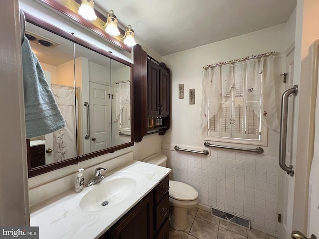 460 Baltimore St, Gettysburg, PA 17325 - full bath with tile walls, vanity, toilet, and tile patterned flooring