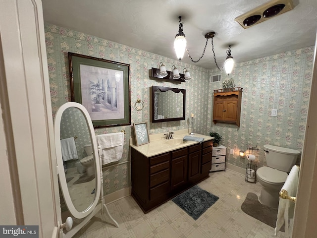 460 Baltimore St, Gettysburg, PA 17325 - full bath with toilet, vanity, baseboards, tile patterned floors, and wallpapered walls