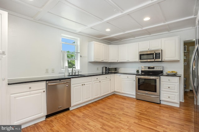 7536 Marks Ave, Nottingham, MD 21236 - kitchen with stainless steel appliances, a sink, coffered ceiling, light wood finished floors, and dark countertops