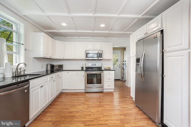 7536 Marks Ave, Nottingham, MD 21236 - kitchen featuring appliances with stainless steel finishes, a sink, light wood-style floors, white cabinetry, and dark countertops