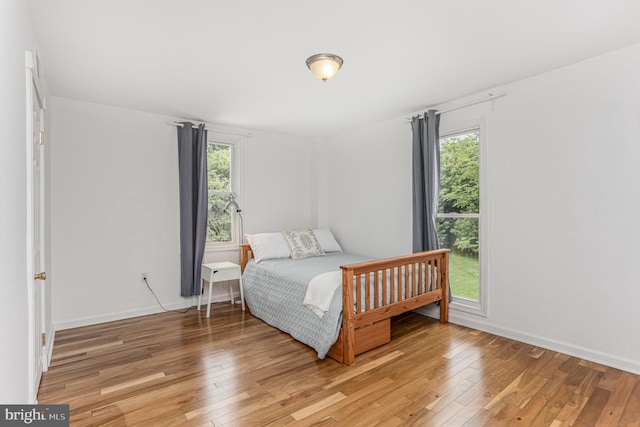 7536 Marks Ave, Nottingham, MD 21236 - bedroom featuring light wood-style floors, multiple windows, and baseboards