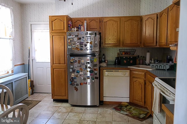 410 Beechwood Ave, Trenton, NJ 08618 - kitchen with white appliances, wallpapered walls, brown cabinetry, and radiator