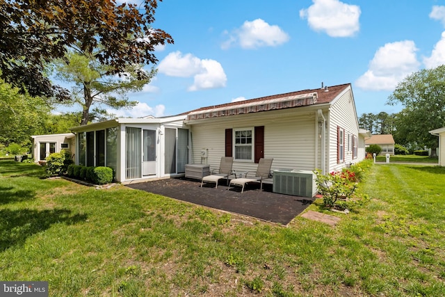 29 Sheffield Pl, Southampton, NJ 08088 - back of property with central AC, a sunroom, a lawn, and a patio area
