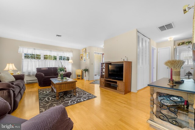 29 Sheffield Pl, Southampton, NJ 08088 - living room featuring a baseboard heating unit, light wood-style flooring, and healthy amount of natural light