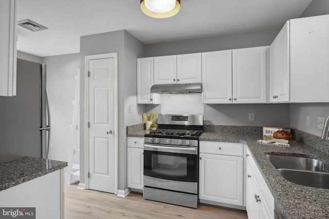 204 Fawn Rdg N, Harrisburg, PA 17110 - kitchen with under cabinet range hood, stainless steel appliances, white cabinetry, and light wood-style floors