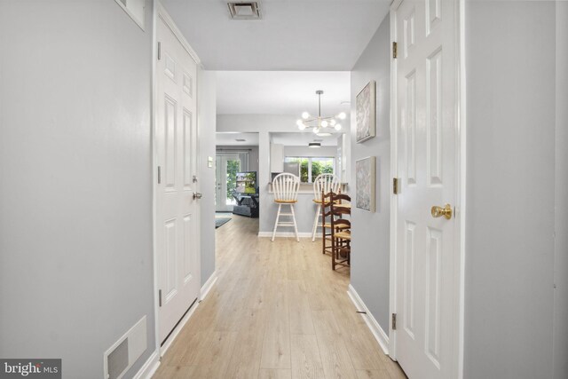 204 Fawn Rdg N, Harrisburg, PA 17110 - hall with light wood-style flooring and a chandelier