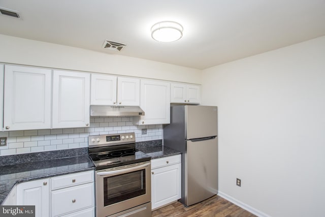 144 Carousel Cir, Doylestown, PA 18901 - kitchen featuring appliances with stainless steel finishes, under cabinet range hood, wood finished floors, white cabinets, and decorative backsplash