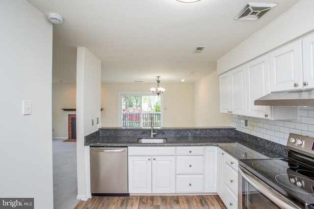 144 Carousel Cir, Doylestown, PA 18901 - kitchen featuring appliances with stainless steel finishes, under cabinet range hood, a sink, white cabinetry, and a chandelier